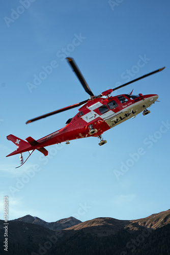 Swiss Rescue Helicopter Flying Over Alpine Mountains