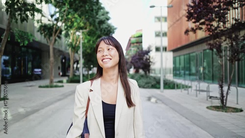 Young asian businesswoman walking in the city in slow motion