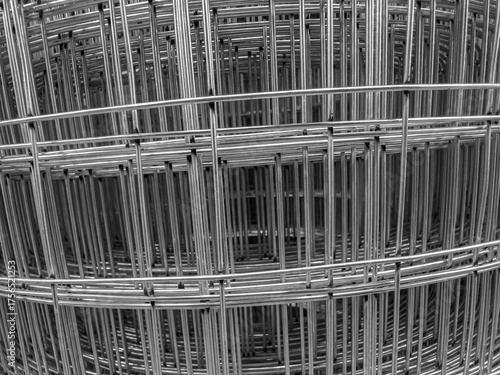 Spiral layers of rolled galvanized welded wire mesh for industrial fencing, reinforcement, and security barriers in construction and agriculture.