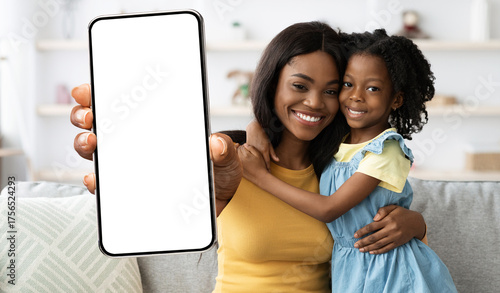 Family Offer. Smiling African American Mom And Daughter Showing Blank Smartphone At Camera, Mother And Child Demonstrating Big Mobile Phone With Empty White Screen, Collage, Mockup