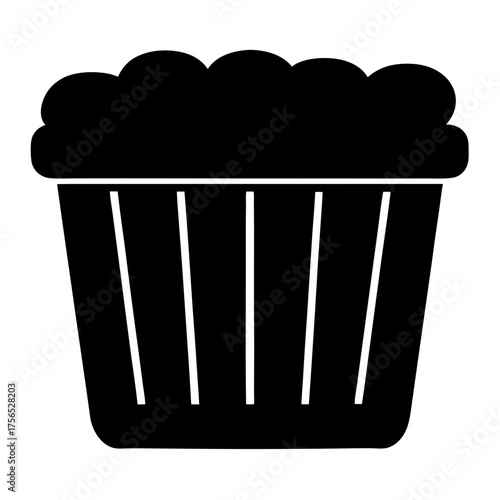 Black silhouette of a cupcake with frosting on a white background