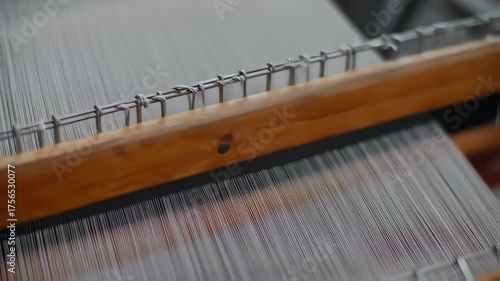 Wallpaper Mural Detailed Close-Up of a Traditional Wooden Weaving Loom in Motion, Threads Creating Fabric Torontodigital.ca