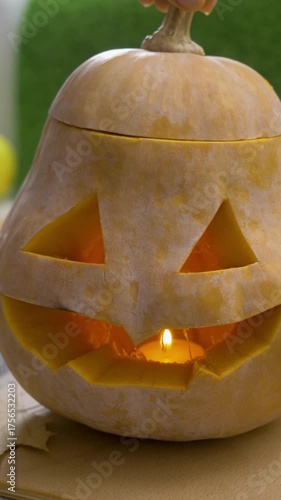 Inside carved pumpkin, candle flame dances. Jack-o-lantern glows with spooky charm. Halloween atmosphere shaped from autumn harvest and firelight, symbol of ancient celebration