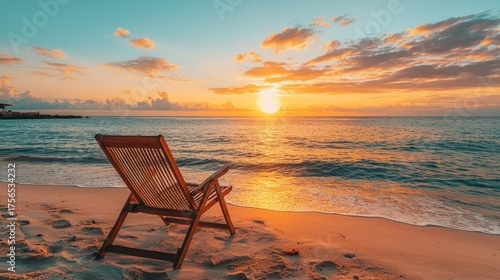Beach chair at sunset, tranquil ocean view, golden hour serenity.