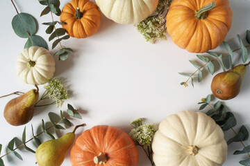 Autumn harvest frame with pumpkins pears and eucalyptus leaves creating a seasonal border for Thanksgiving or fall-themed designs