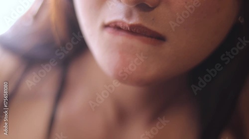 A compilation of subtle facial expressions, showcasing lip movements and delicate skin textures with warm lighting and