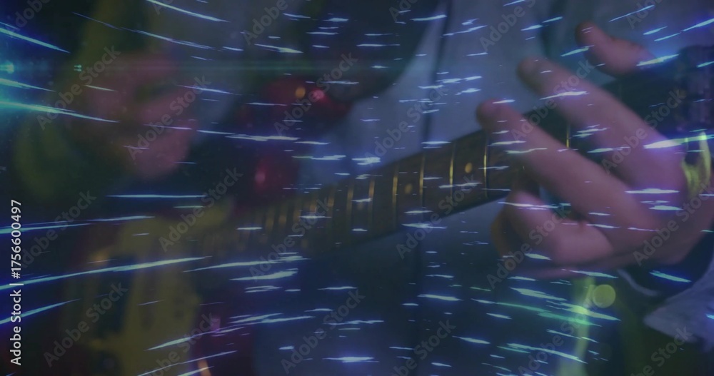 Fototapeta premium Playing musician hands in dark jacket fingering frets on yellow guitar on stage with blue streaks