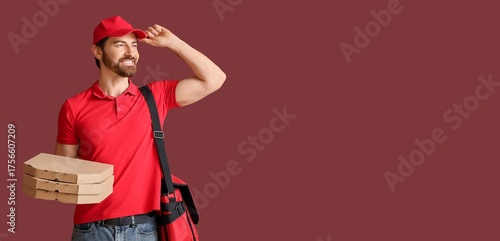 Male courier holding pizza ...