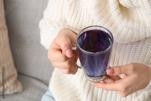 Young woman with glass cup ...