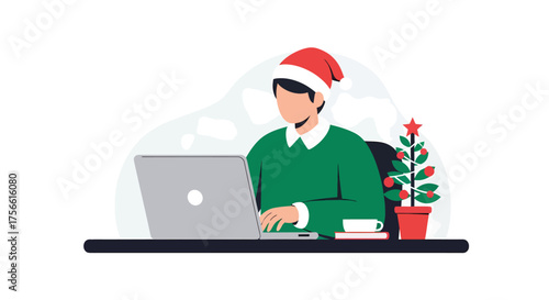 Man wearing santa hat working on laptop at desk with christmas tree during holiday season, showcasing modern festive workspace.