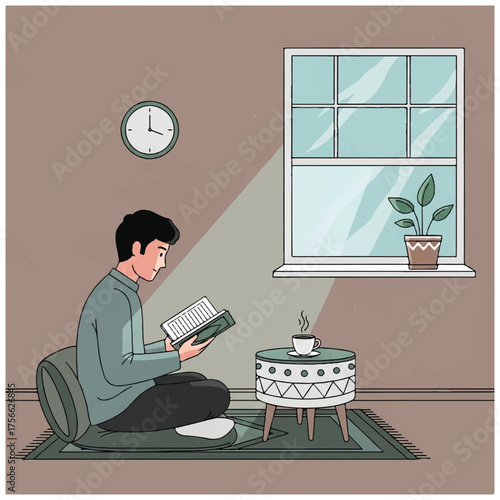 Man reading a book indoors seated on a rug with a cushion.