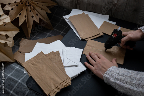 Master class of using hot glue making craft paper snowflakes for conscientious Christmas decor. Sustainable celebration minimal responsible DIY holiday project. Step by step instruction 