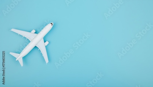 Top View of White Airplane on Blue Background