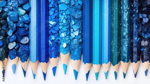 Array of pencils with matching color bits, creating a gradient of blue hues on a white base