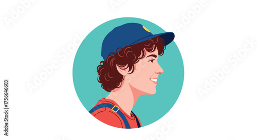 A young person wearing a blue cap and overalls smiles brightly while looking to the side.