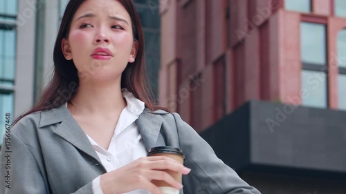 Young asian businesswoman checking time on smartwatch in urban, business woman impatient for appointment with anxiety and urgency in corporate career, female worried about schedule and deadline.