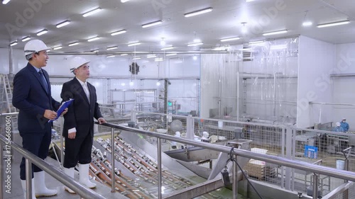 Executive manager and engineer inspecting food processing factory, businessman discussing quality control and production, team in industrial, executive checking document report for quality management.