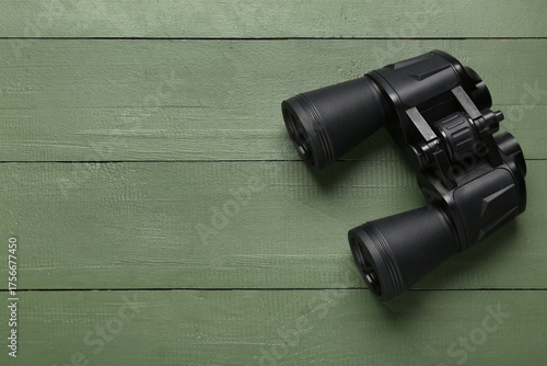 Modern binoculars on green ...