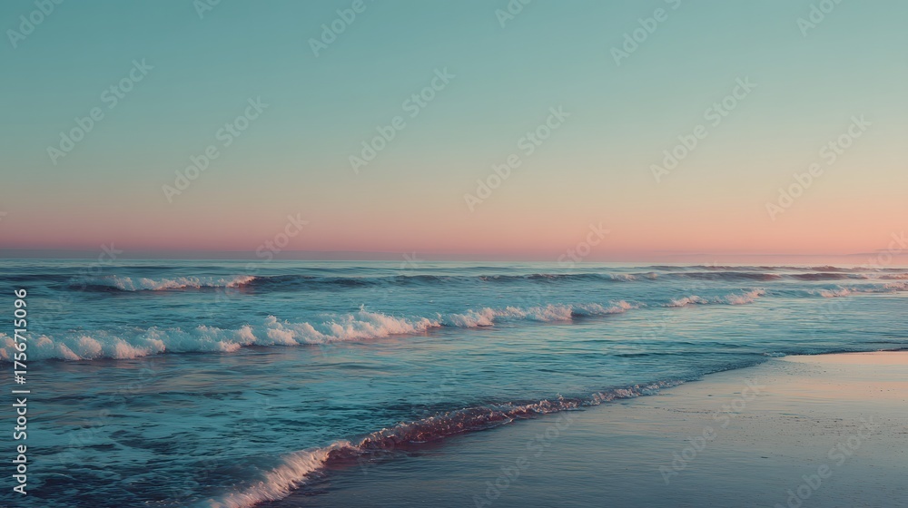 Obraz premium Gentle waves wash ashore on a sandy beach under a pastel sky.