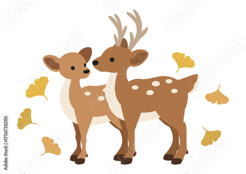 イチョウの葉が舞う中で寄り添う二頭の鹿