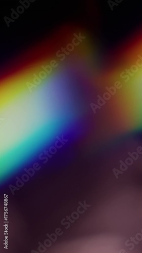 Vertical video. Blur light. Abstract illumination. Defocused blue yellow green multicolor rainbow optical spectrum sparkle flicker on art background.