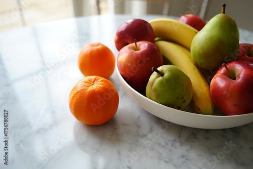 Fresh fruit bowl with oranges and apples on a table