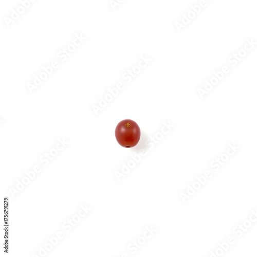 A solitary red grape is placed at the center of a pristine white background