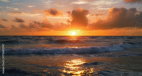 Fototapeta Naklejka Na Ścianę i Meble -  Ocean Wave at Sunrise with Cloudscape and Golden Light Reflection
