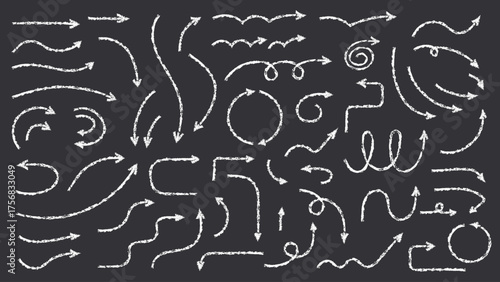Collection of hand drawn chalk arrows in various directions on dark background