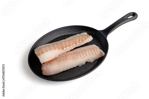Two pieces of fish fillet on a black cast iron frying pan isolated on white background