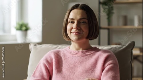 Woman in pink sweater relaxes with closed eyes during daytime