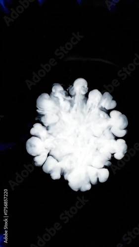 Abstract blue ink splatter against white background