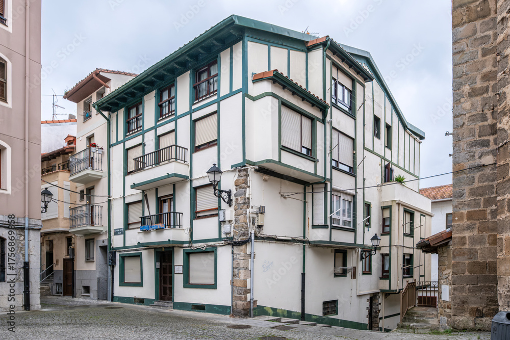 Fototapeta premium Traditional Basque House with White and Green Half-Timbered Facade in Bermeo Old Town
