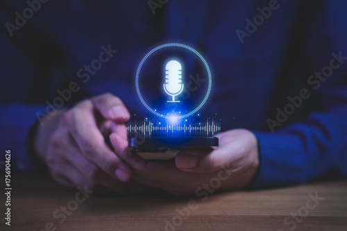 Person holding smartphone with glowing microphone icon and sound wave hologram, symbolizing voice recognition, AI assistant, digital communication, and smart technology innovation in modern devices.