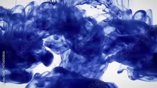 Blue Ink Dropping and Dissolving in Water on White Background