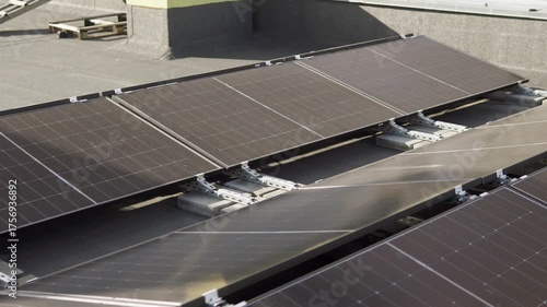Modern rooftop solar array on a tall building, highlighting sustainable city infrastructure.