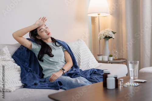 Young woman feeling unwell resting on sofa