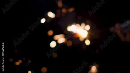 Defocused shot of sparker burning in dark background. Diwali celebration background. Fireworks during Diwali festival celebration. New year, Christmas and Diwali concept. 