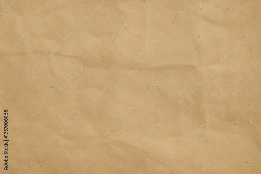 Obraz premium Detailed texture of wrinkled brown paper with natural shadows and folds, suitable for vintage background or eco-friendly concept..