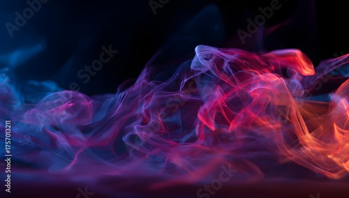 Abstract swirling colorful smoke or vapor illuminated with vibrant neon blue pink and orange light against a dark background for graphic design