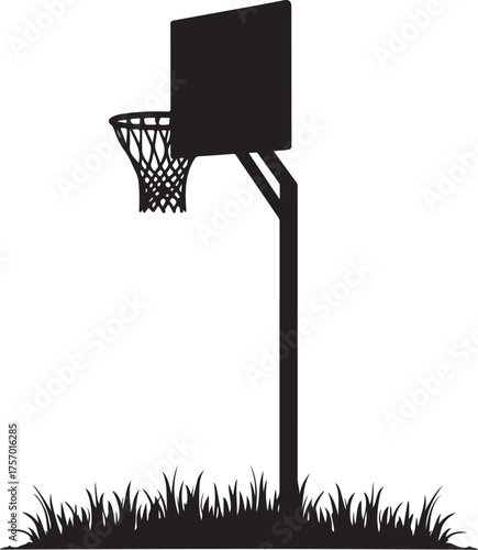 Black silhouette of a basketball hoop and net over grass