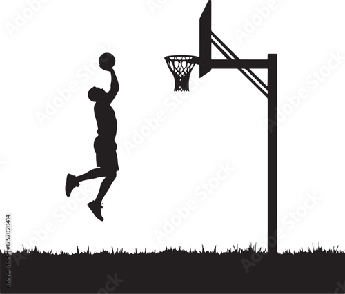 Silhouette of basketball player jumping to dunk ball