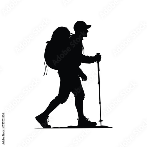 A hiker with backpack and walking stick in dramatic silhouette