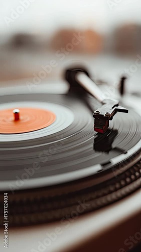 Vintage vinyl record player needle on spinning turntable disc showcase