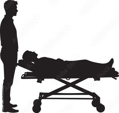 Silhouette of man standing next to patient on medical stretcher