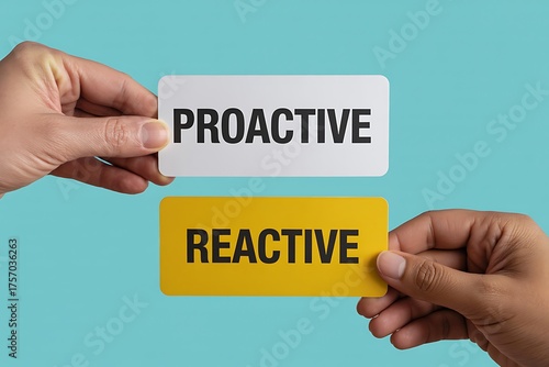 Two hands hold contrasting cards displaying the words proactive and reactive against a solid blue background symbolizing choice