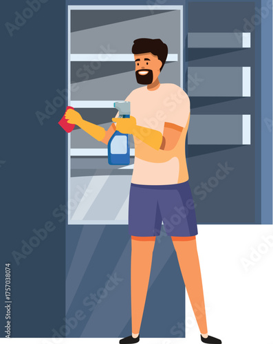 Smiling man wearing gloves cleaning refrigerator with disinfectant spray and cloth