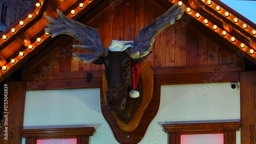 Wroclaw, Poland 19 12 2024: Christmas market display with festive lights and decorative moose head in Wroclaw, Poland. Sound