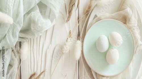 White Eggs on Pale Blue Plate Surrounded by Soft Textiles and Dried Plants in Light Neutral Setting
