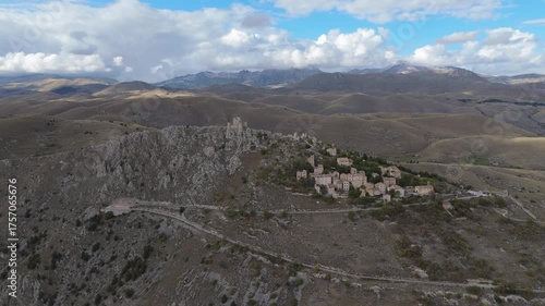 Drone aerial view of Monte Calascio, Abruzzo, featuring the medieval Rocca fortress and spectacular surrounding mountain landscapes